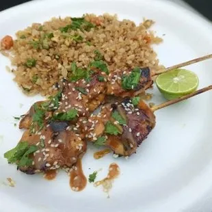 a plate of food with rice and meat