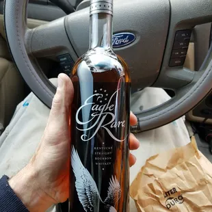 a hand holding a bottle