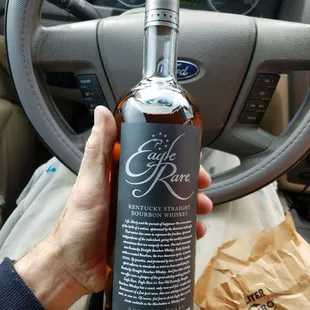 a hand holding a bottle