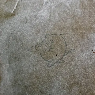 Cute stamped design on bakery bags - cat(?) carrying bread on a board?