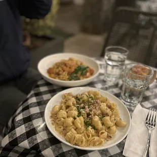 a plate of pasta and a glass of water