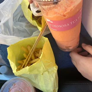 Parmesan fries , spicy chicken , and strawberry passion fruit smoothies.