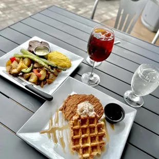 a plate of waffles and a glass of wine