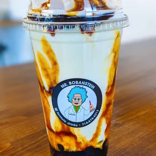a cup of iced coffee on a table
