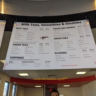 a woman standing in front of a menu