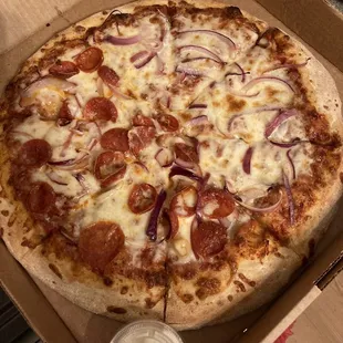 Traditional eight cut pizza with purple onions and pepperoni