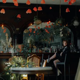 a woman sitting at a bar