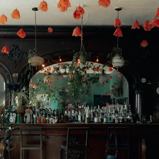a bar with a lot of flowers hanging from the ceiling