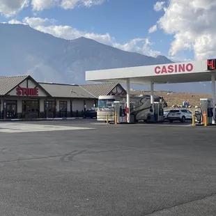 a gas station with mountains in the background
