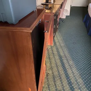 Broken door to refrigerator cabinet.