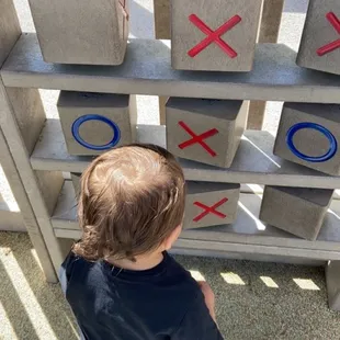 Son playing tic tac toe
