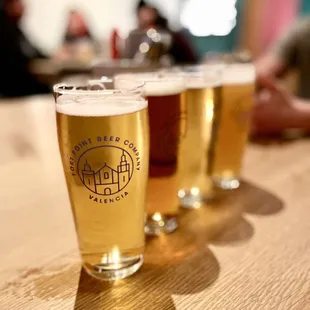 a row of beer glasses on a table