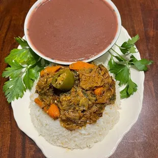 a plate of food with rice and a bowl of soup