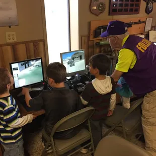 Our friendly docents help new flyers on some of our desktop flight simulators.