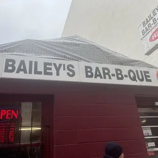 a man standing in front of a barbeque