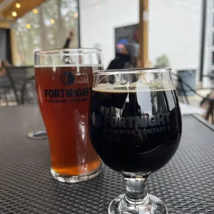 two glasses of beer on a table