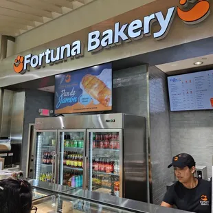 a woman ordering food at the counter