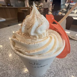 Latte with whipped cream and cinnamon topping