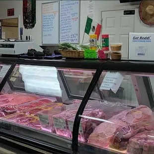 a display case of meat in a grocery store