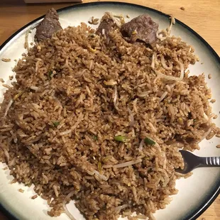 a plate of rice and meat