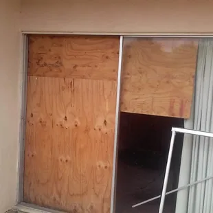 Rooms with busted out windows covered by boards.