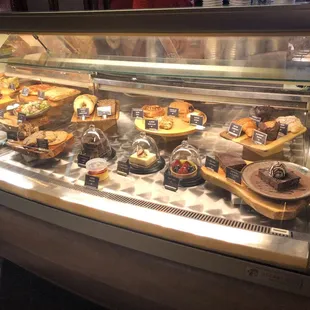 a display case with a variety of pastries