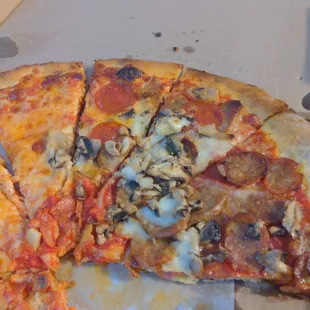 Half gourmet half cheese. Had to cut it again at home. Whole pizza in 5 slices