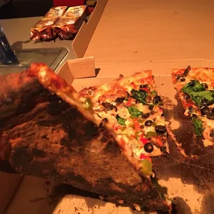 a slice being taken out of a pizza box