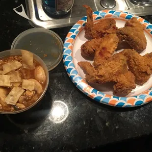 a plate of fried chicken and a bowl of soup