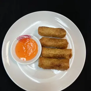 a plate of food with dipping sauce