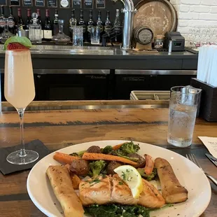 Salmon on a bed of spinach. With savory broccoli, carrots, and potatoes.