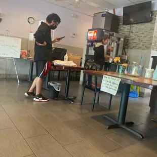 a man using his cell phone in a restaurant