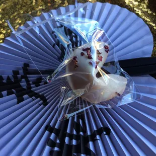 a fortune cookie on a paper fan