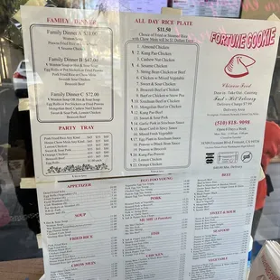 a menu on a table in front of a window