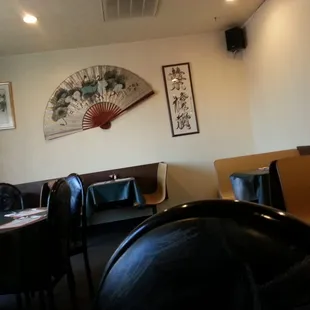 a dining room with a fan on the wall