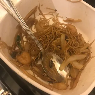 a bowl of noodles with a spoon in it