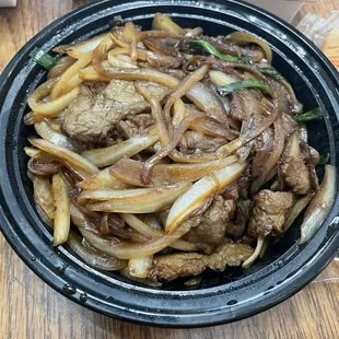 beef and onions in a bowl