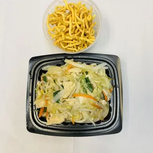 a plate of noodles and a bowl of fries