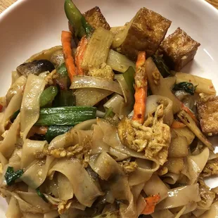 a plate of noodles and tofu