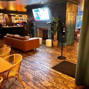 a living room with wood flooring and a bar