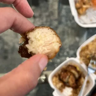 a hand holding a piece of bread