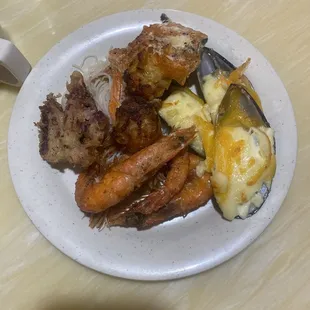 Fried shrimp with head on,mussel with cheese, rice vermicelli noodles, squid,fish and stuff mushrooms.