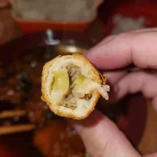 a person holding a piece of food