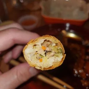 a person holding a piece of food