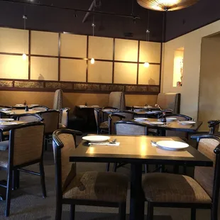 a dining area with tables and chairs