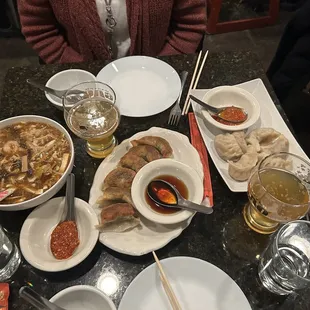 Spread of dumplings and hot and sour soup