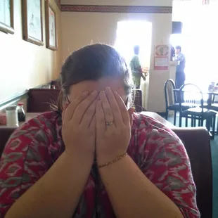 a woman covering her face