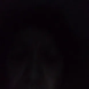 a blurry image of a person's face in the dark