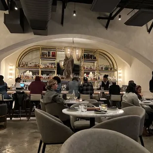 people sitting at tables in a restaurant