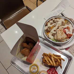 a tray of food and a tray of fries